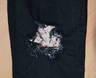 Vintage-Patch Jeans Repair Reverse Repair Undercover Patch Fawn Trailing Rose on black denim jeans