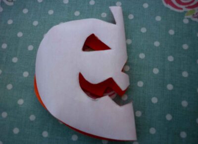 iron on pumpkin face motif folded in half