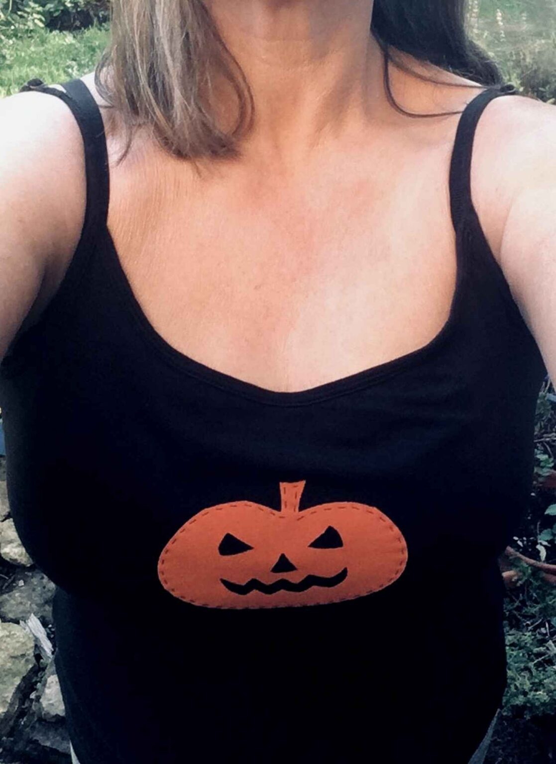 black strappy camisole vest top with orange pumpkin face motif iron on upcycle being worn